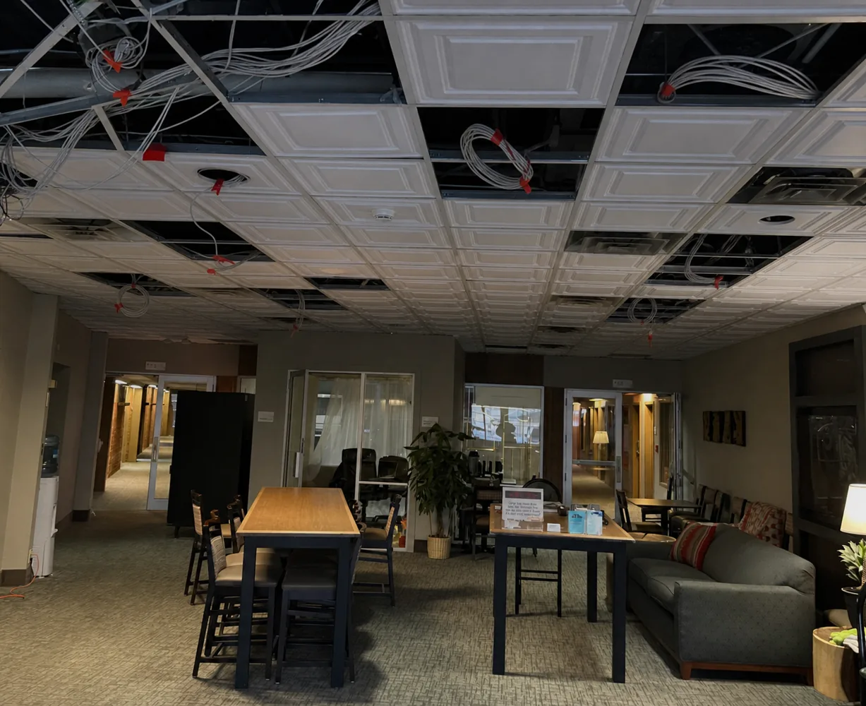 Commercial tenant-improvement ceiling electrical work before completion